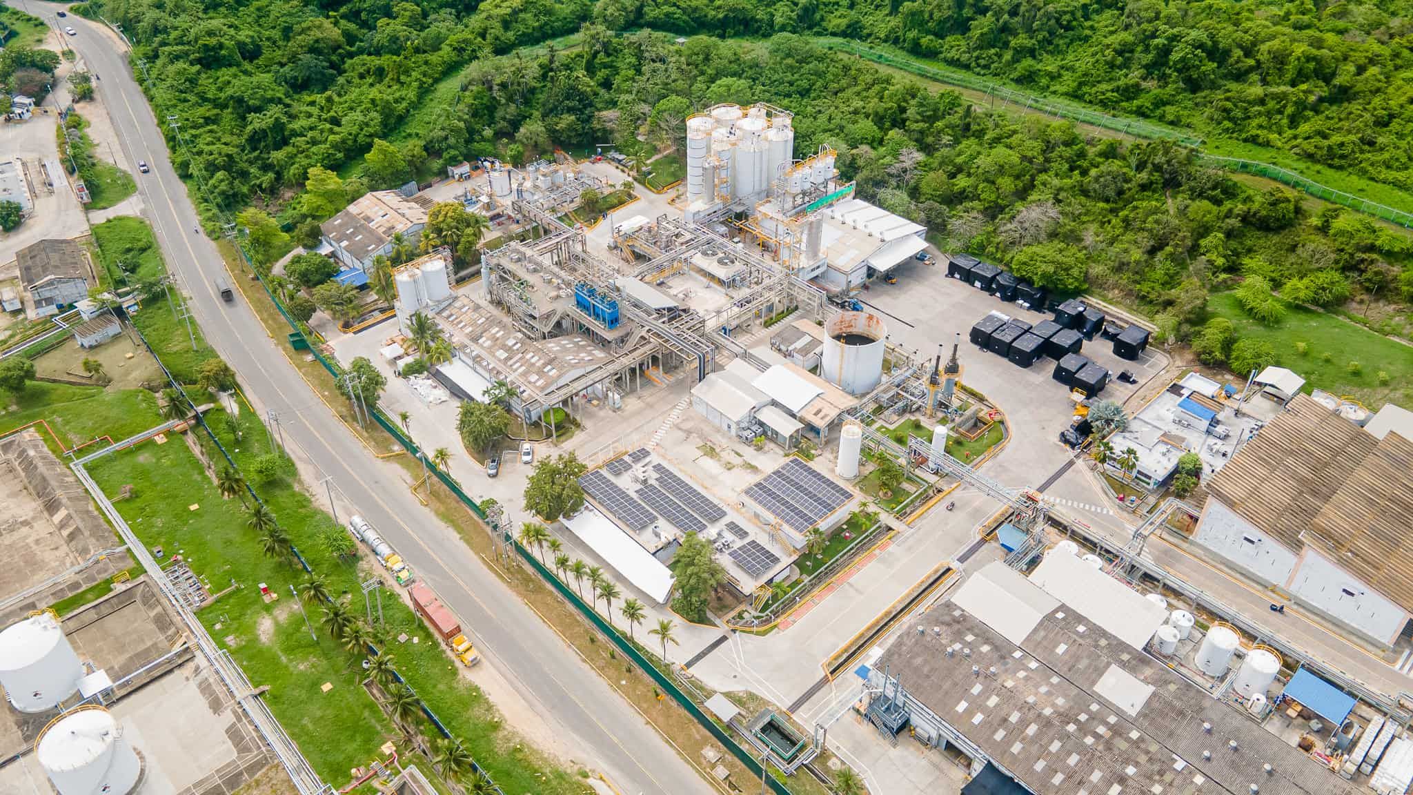 An aerial view of large manufacturing facility surrounded by palm trees